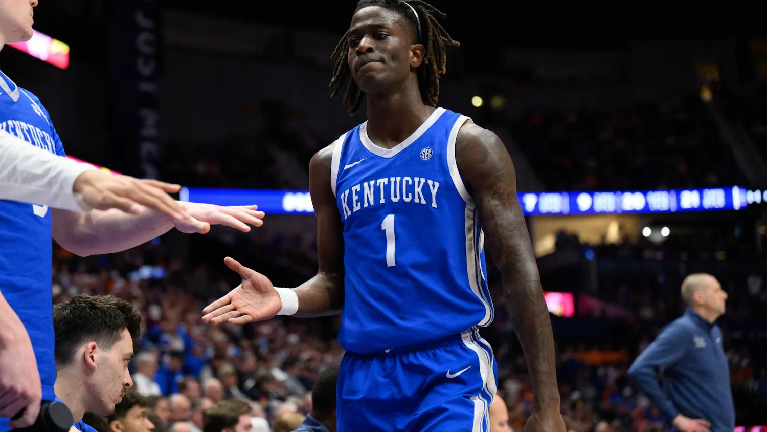 Kentucky guard Denzel Aberdeen (1) high fives his bench after being subbed out during the first half of an SEC Men's Basketball Tournament quarterfinal game against Florida, Friday, March 13, 2026, in Nashville, Tenn.