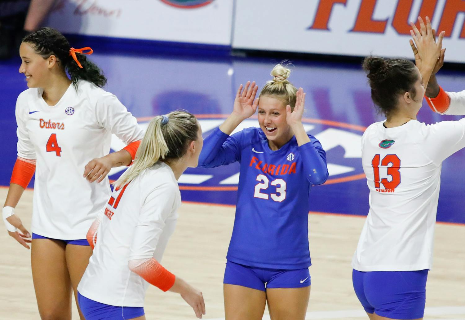 Florida volleyball&#x27;s Elli McKissock (23), Sofia Victoria (4), Marlie Monserez (21) and Merritt Beason (13) celebrate during the Gators&#x27; loss to Mississippi State on Sept. 24. The team hosted Jacksonville Saturday for its annual Fan Day exhibition match. 