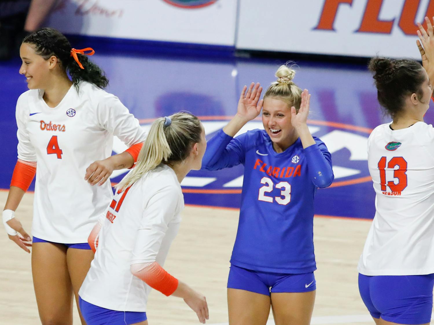 Florida volleyball&#x27;s Elli McKissock (23), Sofia Victoria (4), Marlie Monserez (21) and Merritt Beason (13) celebrate during the Gators&#x27; loss to Mississippi State on Sept. 24. The team hosted Jacksonville Saturday for its annual Fan Day exhibition match. 