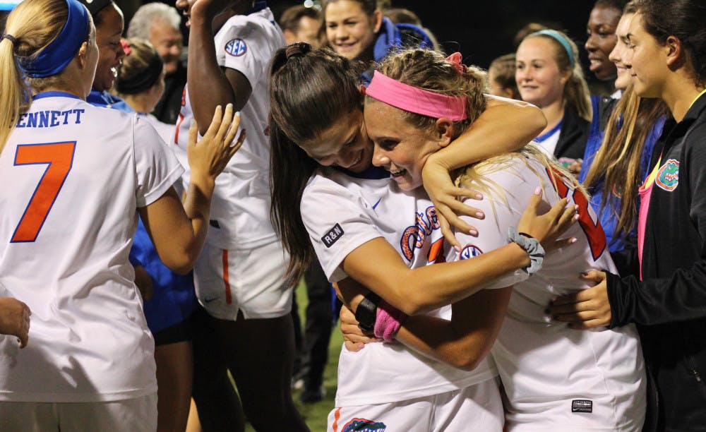 <p>Jessie Holmes and Parker Roberts hug after Florida's 1-0 over USF in the second round of the NCAA Tournament.</p>