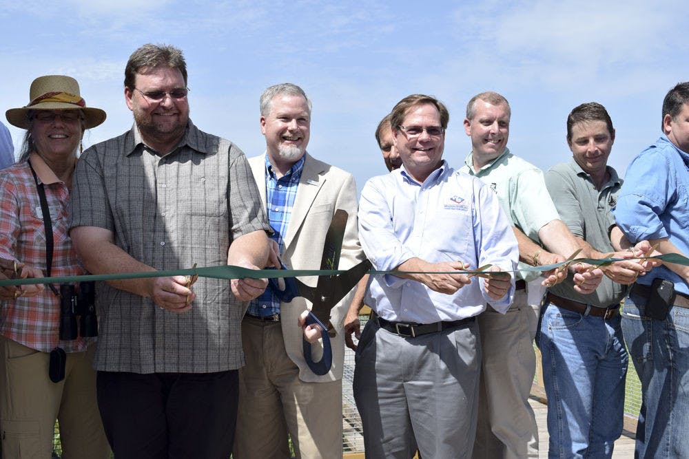 From left: Helen Warren, City Commissioner; Brad Purcell, South Florida Water Management District; Ed Braddy, Mayor; David Lewis, Wharton Smith; Chris Wynn, Florida Fish and Wildlife; Chris Keller, Wetland Solutions; and Tom Frick, FDEP, cut the ribbon at Friday's grand opening of Sweetwater Wetlands Park, located at 325 SW Williston Road.
