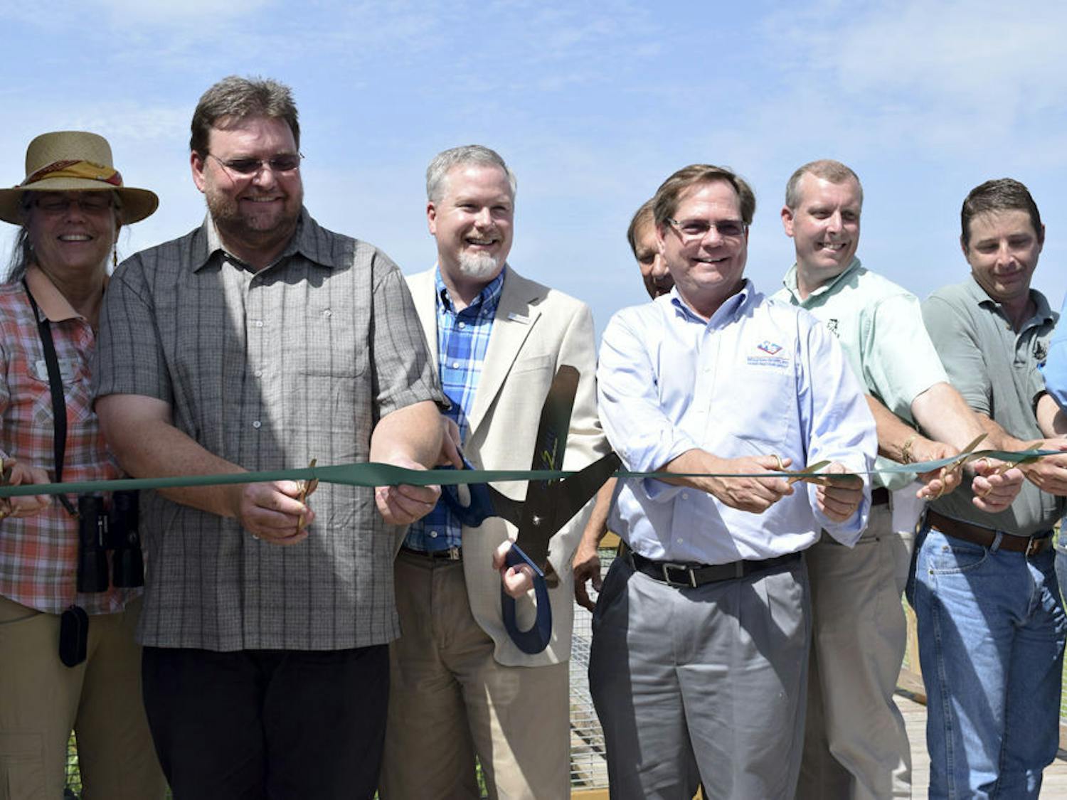 From left: Helen Warren, City Commissioner; Brad Purcell, South Florida Water Management District; Ed Braddy, Mayor; David Lewis, Wharton Smith; Chris Wynn, Florida Fish and Wildlife; Chris Keller, Wetland Solutions; and Tom Frick, FDEP, cut the ribbon at Friday's grand opening of Sweetwater Wetlands Park, located at 325 SW Williston Road.
