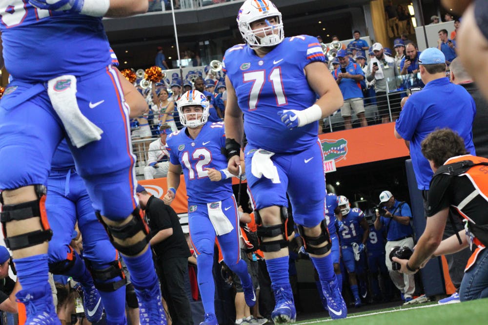 The Florida football team runs out onto the field during UF's 33-17 loss to Michigan on Saturday at AT&amp;T Stadium in Arlington, Texas. 