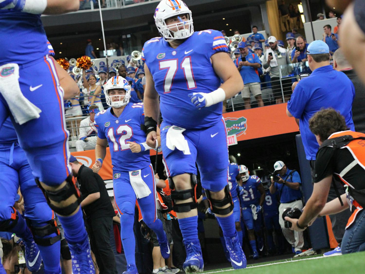 The Florida football team runs out onto the field during UF's 33-17 loss to Michigan on Saturday at AT&T Stadium in Arlington, Texas.