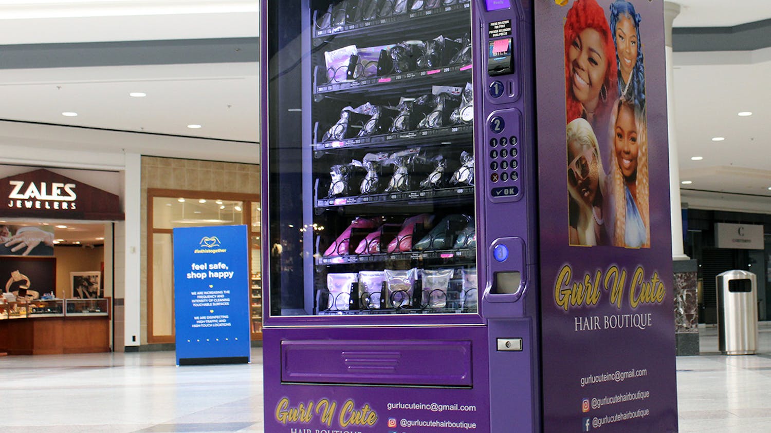 A purple vending machine owned by the Gurl U Cute Hair Boutique sits near the entrance of Oaks Mall in Gainesville on Thursday, Feb. 18, 2021. The vending machine has wig bundles and false lashes for purchase.