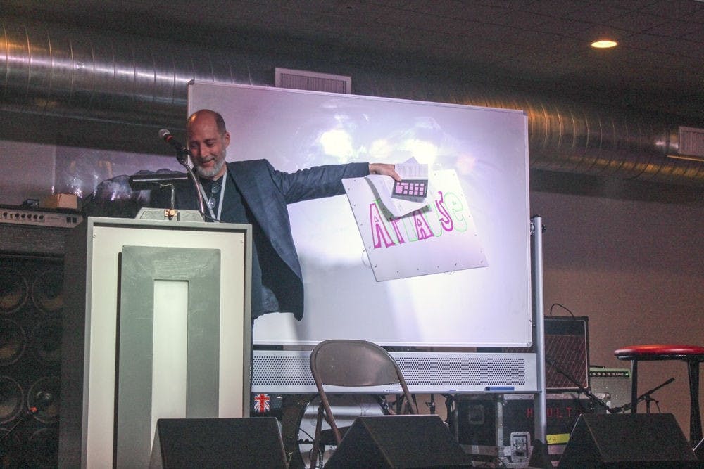 Tom Shroder, former editor at The Washington Post, author of “Acid Test: LSD, Ecstasy and the Power to Heal”, and one of the event’s masters of ceremonies, explains the rules of the frank Adventure Hunt in The Wooly on Wednesday evening. Conference participants split into teams and set off on a scavenger hunt across Gainesville.