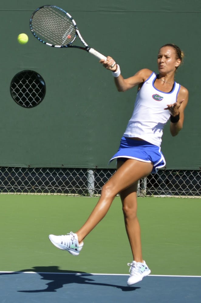 Senior Olivia Janowicz swings at the ball during her second-round singles match against FSU freshman Eduarda Dos Santos on Oct. 11, 2013, at the Bedford Cup at the Ring Tennis Complex.