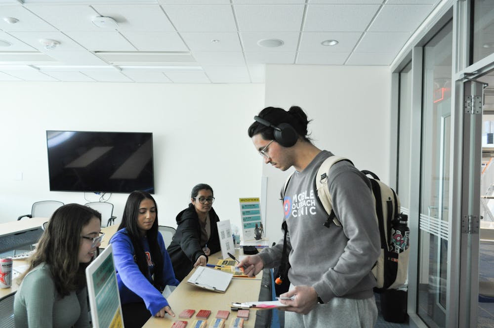 <p>Three student volunteers provide information about the Human Rights Coalition’s Decline to Answer Campaign at their ID drive at the Reitz Union on Thursday, Feb. 2, 2024.</p>