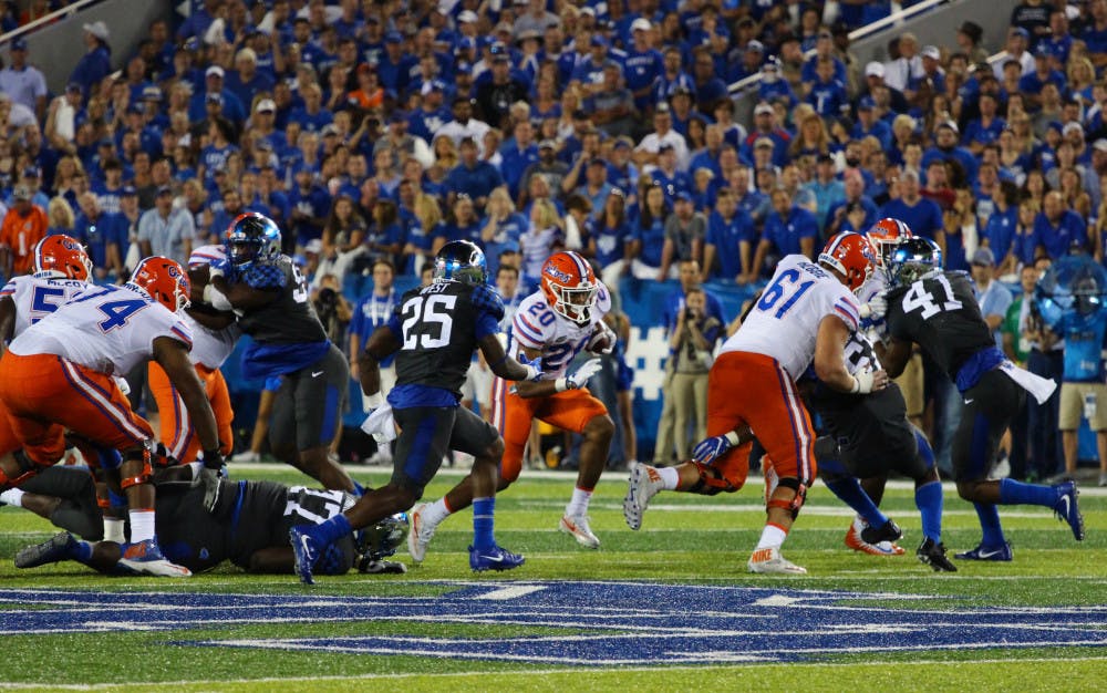 UF offensive lineman Brett Heggie blocks for Malik Davis during Florida's 28-27 win against Kentucky on Sep. 23, 2017, at Kroger Field.