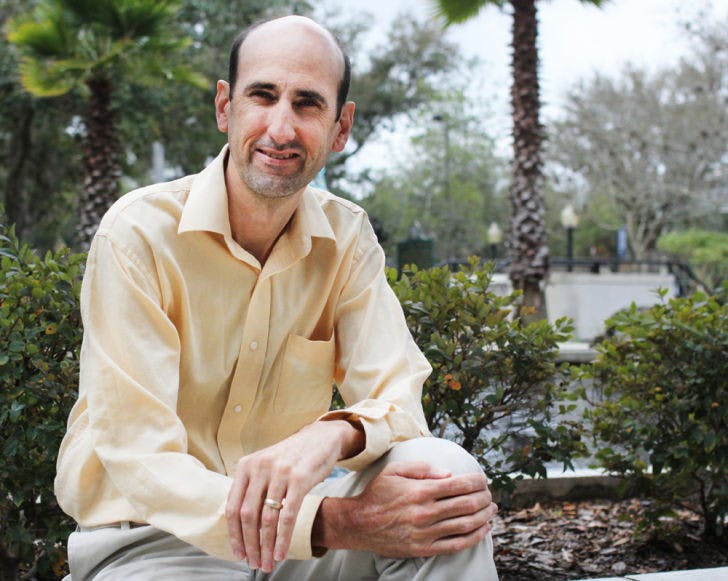 Current District 4 Gainesville City Commissioner Randy Wells sits on a ledge at City Hall on Feb. 12. Wells is the current chairman of the Equal Opportunity Committee and Metropolitan Transportation Planning Organization.