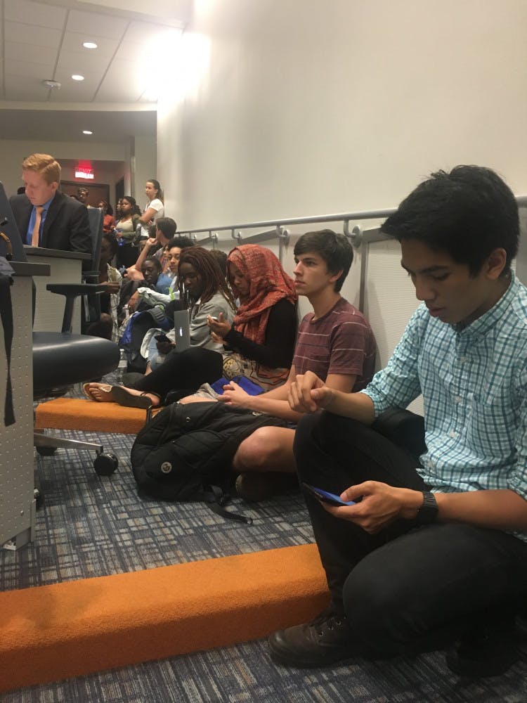 Students sit in at the Student Government Student Senate meeting on Tuesday. Although 43 students signed up for public debate, more students filled the chambers to object senators’ silence regarding the lack of funding for the Counseling &amp; Wellness Center and Richard Spencer’s visit to UF on Thursday.