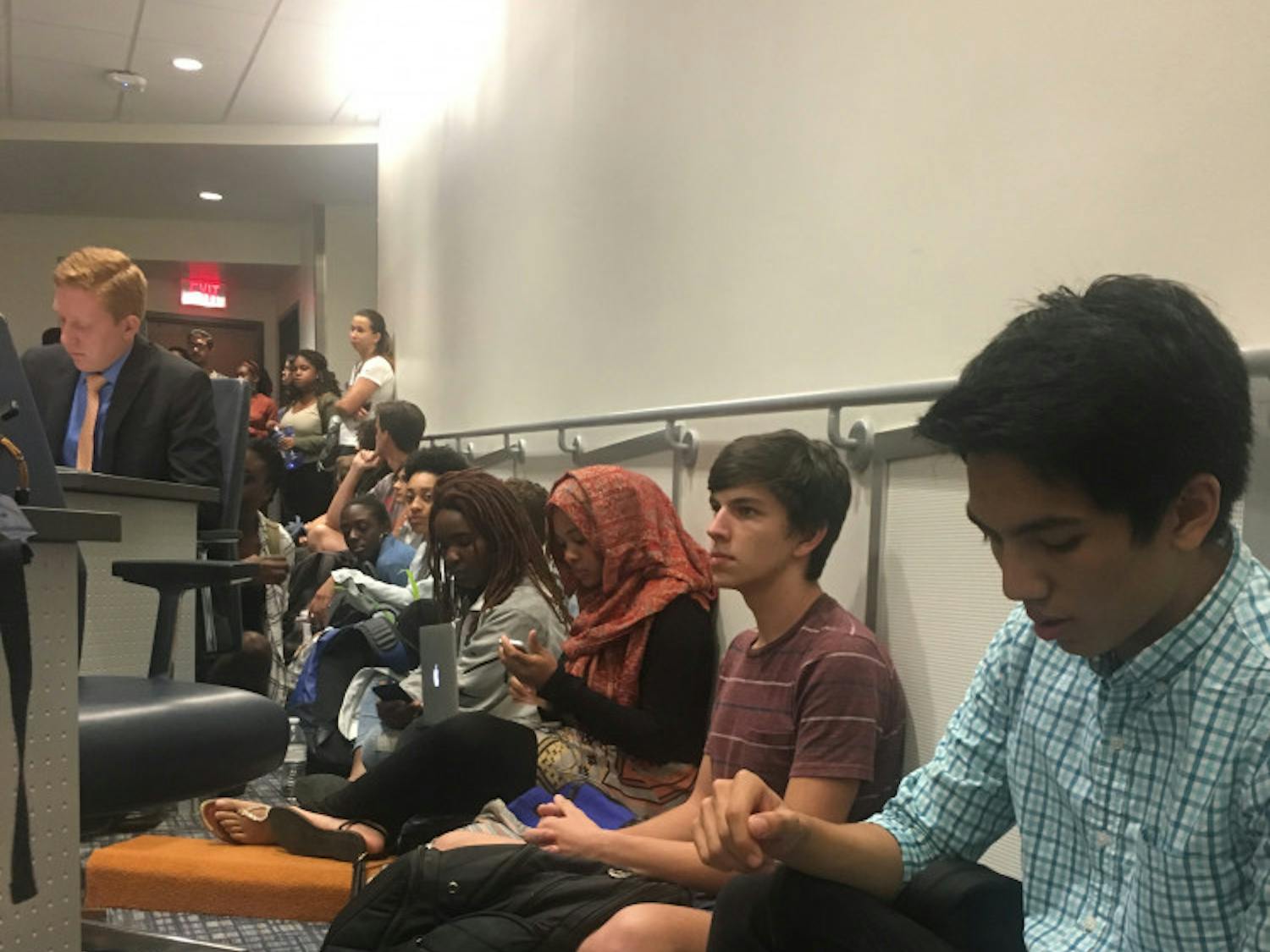 Students sit in at the Student Government Student Senate meeting on Tuesday. Although 43 students signed up for public debate, more students filled the chambers to object senators’ silence regarding the lack of funding for the Counseling & Wellness Center and Richard Spencer’s visit to UF on Thursday.