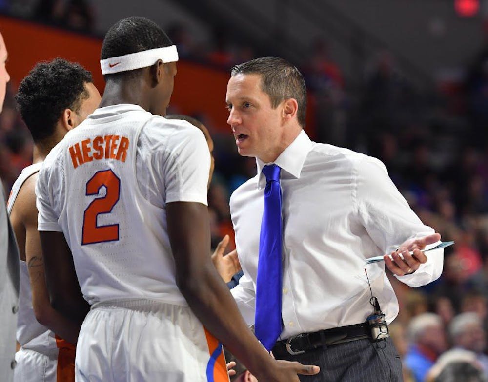 <p>UF guard Eric Hester talks with coach Mike White during Florida's 94-71 win over the University of Arkansas at Little Rock on Dec. 21, 2016, in the O'Connell Center.</p>