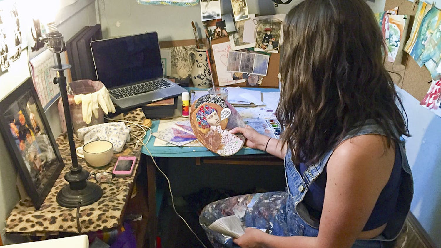Horner examines one of her pieces in her Gainesville studio; though she makes art to sell, she also makes art for pleasure, like the piece she holds.