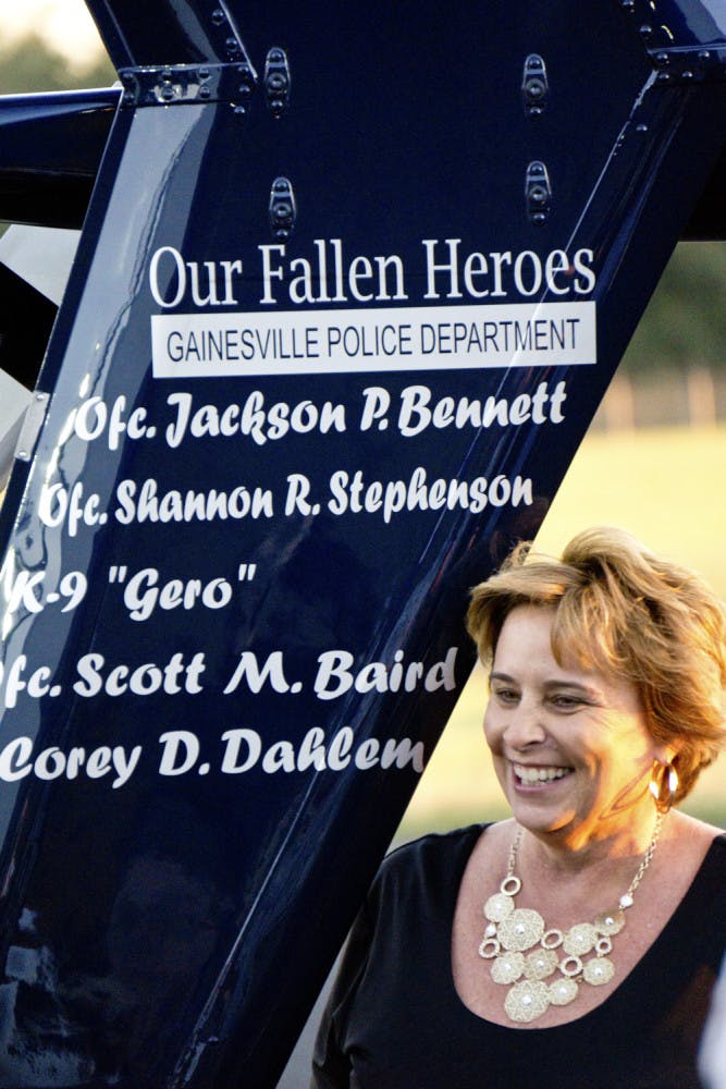 Sally Dahlem, widow of Lt. Corey Dahlem, stands next to a helicopter that was repainted to memorialize her husband and other fallen police officers. “I think it’s beautiful,” she said. “It was a wonderful surprise.”