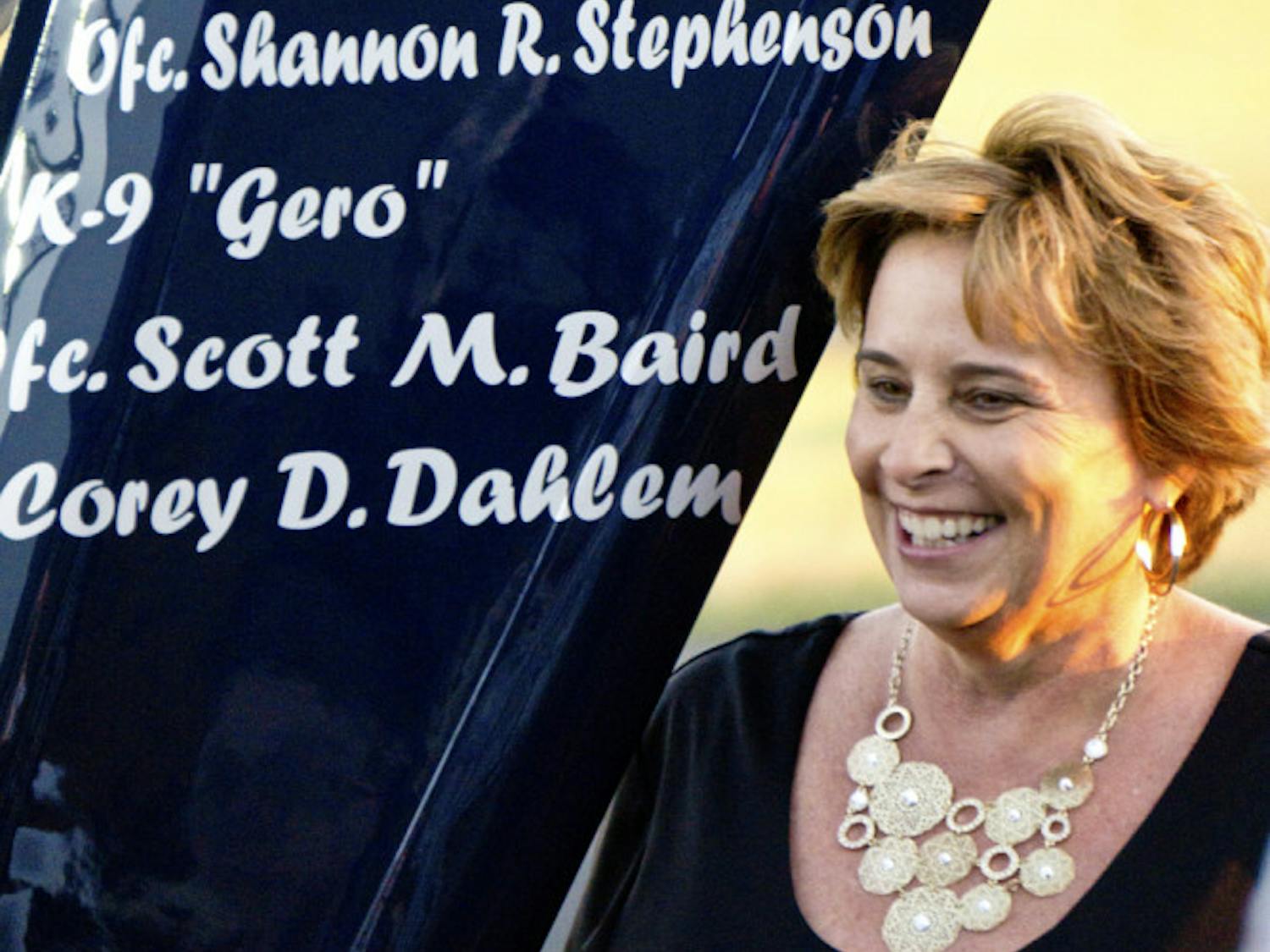 Sally Dahlem, widow of Lt. Corey Dahlem, stands next to a helicopter that was repainted to memorialize her husband and other fallen police officers. “I think it’s beautiful,” she said. “It was a wonderful surprise.”