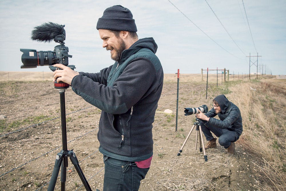 Michael Nichols (left), a UF alum and filmmaker, operates a camera while his friend and partner, Christopher Walker, does the same. Their latest film, titled “Welcome to Leith,” will make its East coast debut at the 2015 Florida Film Festival in April.