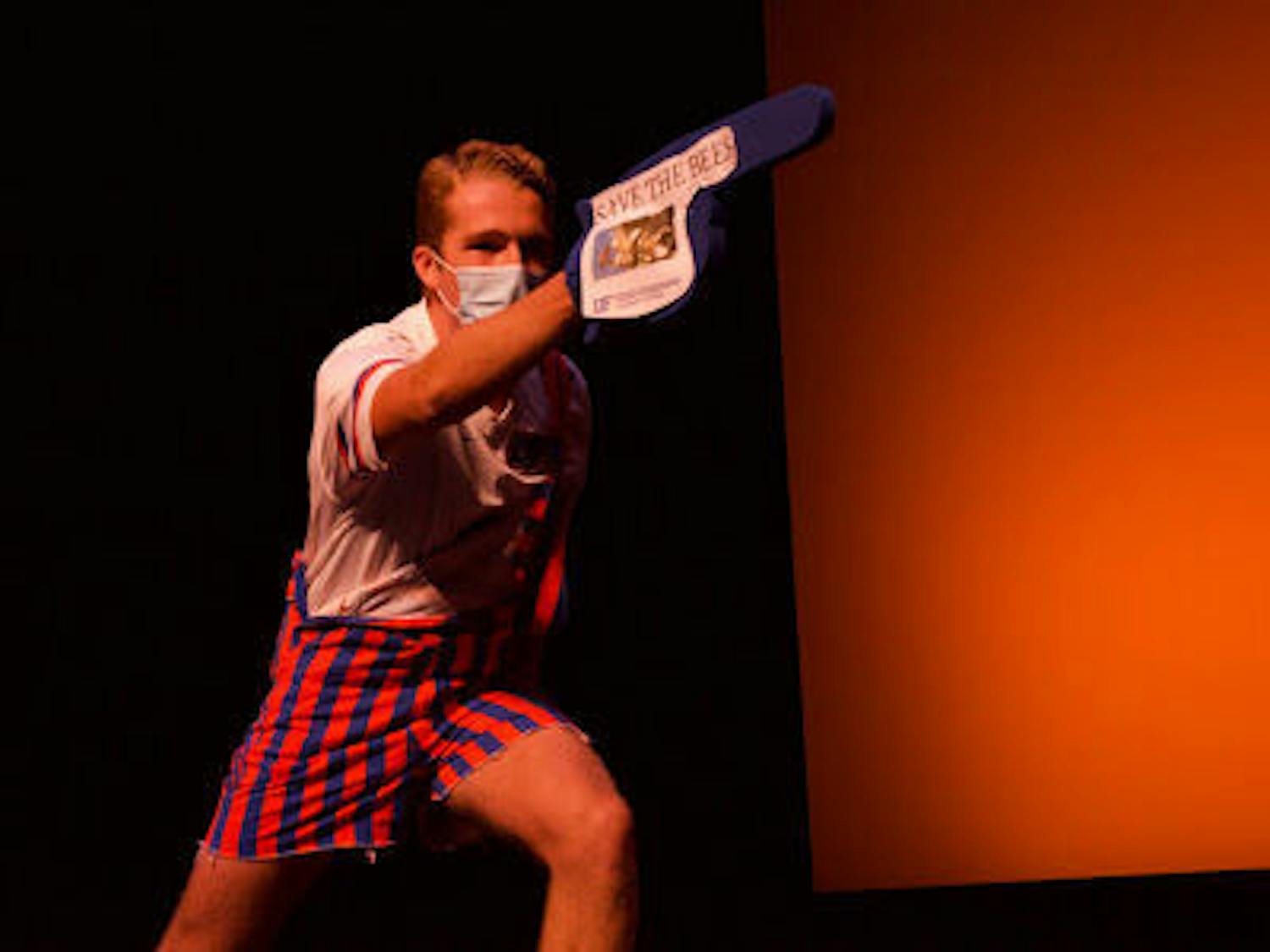 Robert Shulte points a foam finger with the words “save the bees” at the Homecoming Leadership Pageant. The pageant will air today at 7 p.m. (Photographer: Julia Quinn)