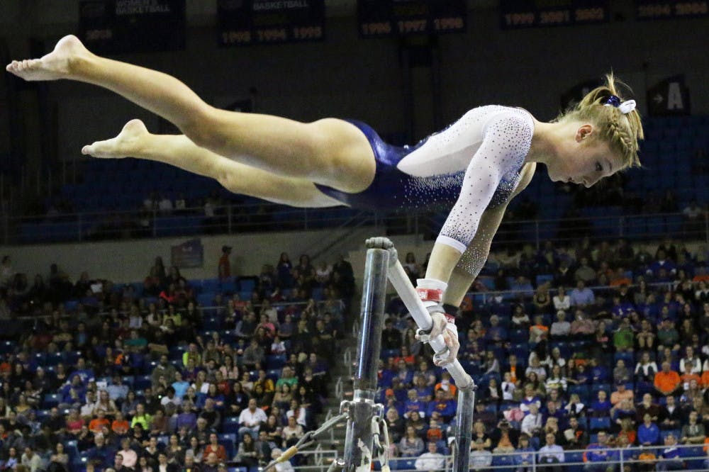 <p>Freshman Alex McMurtry competes on the uneven parallel bars during Florida's win against Auburn on Friday in the O'Connell Center.</p>