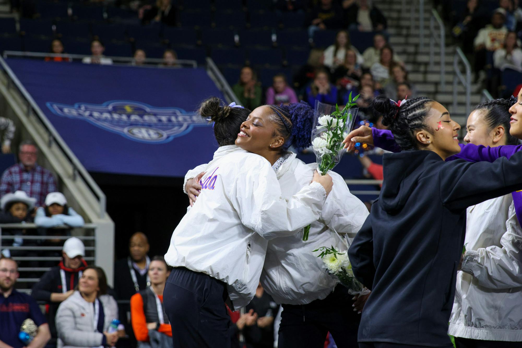 Florida freshman Kayla DiCello (left) and graduate student Trinity Thomas (right) hug following the Gators' win at the Southeastern Conference Championships Saturday, March 18, 2023.