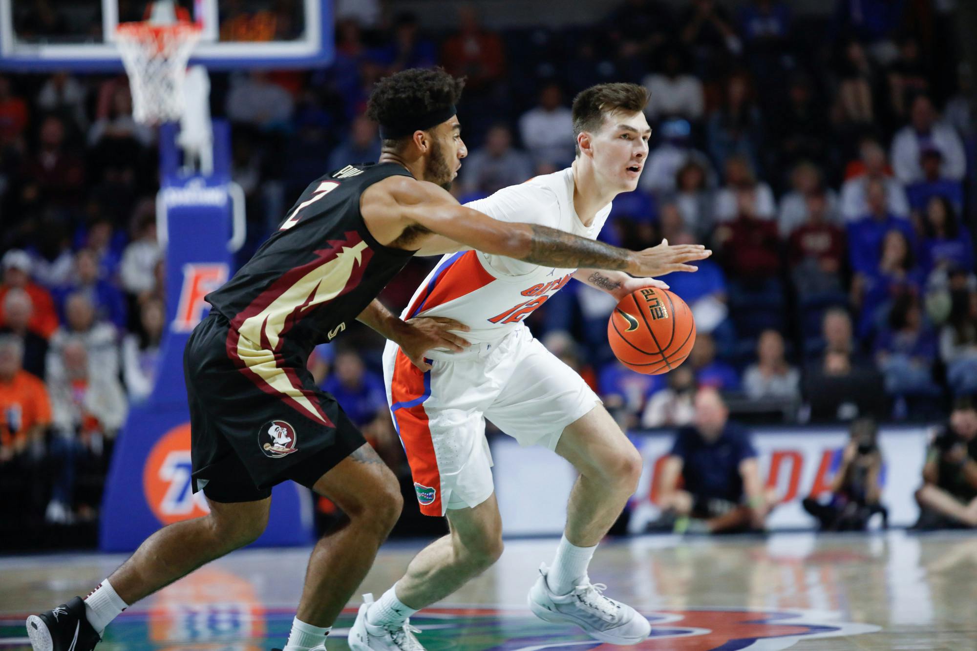Florida's Colin Castleton dribbles the ball and fends off a Florida State defender during the Gators win over the Seminoles on Nov. 14.