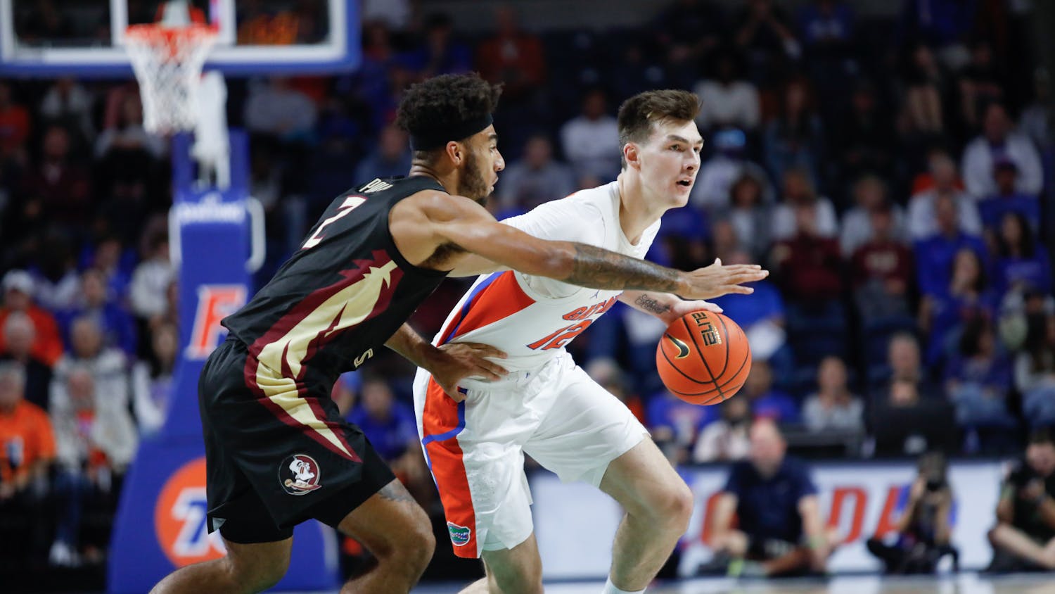 Florida's Colin Castleton dribbles the ball and fends off a Florida State defender during the Gators win over the Seminoles on Nov. 14.