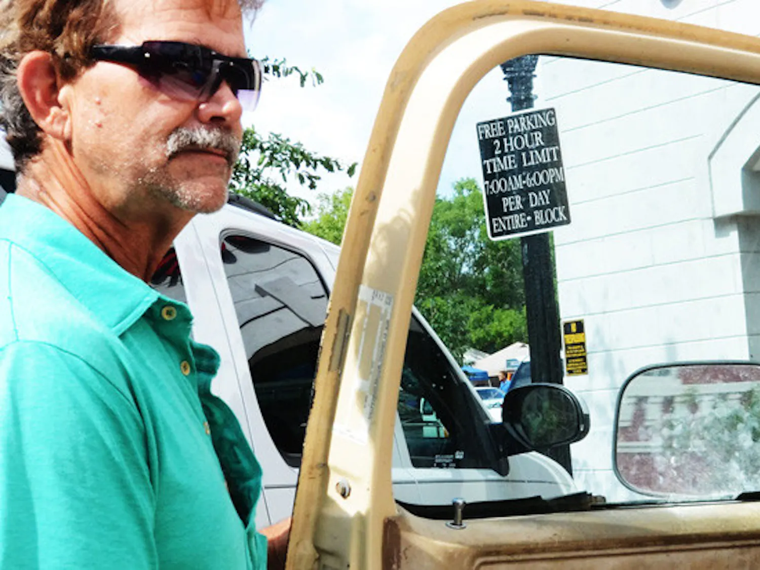 Edward Dowling enters his truck in front of a free parking sign near The Hampton Inn & Suites in downtown Gainesville Wednesday.