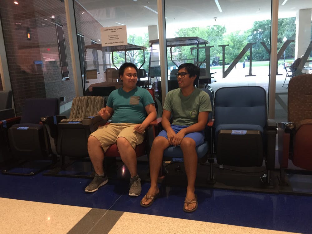 <p><span>Daniel Olis (left) and Ian Arcena test chairs in the Reitz Union for renovations in the auditorium July 11.</span></p>