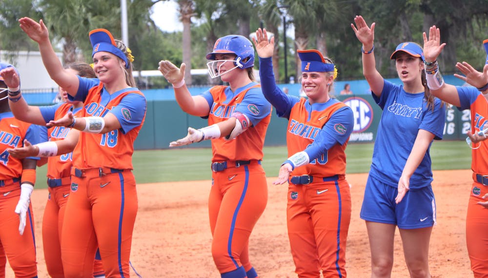 Members of the Florida softball team celebrate after a 1-0 victory over USF Friday