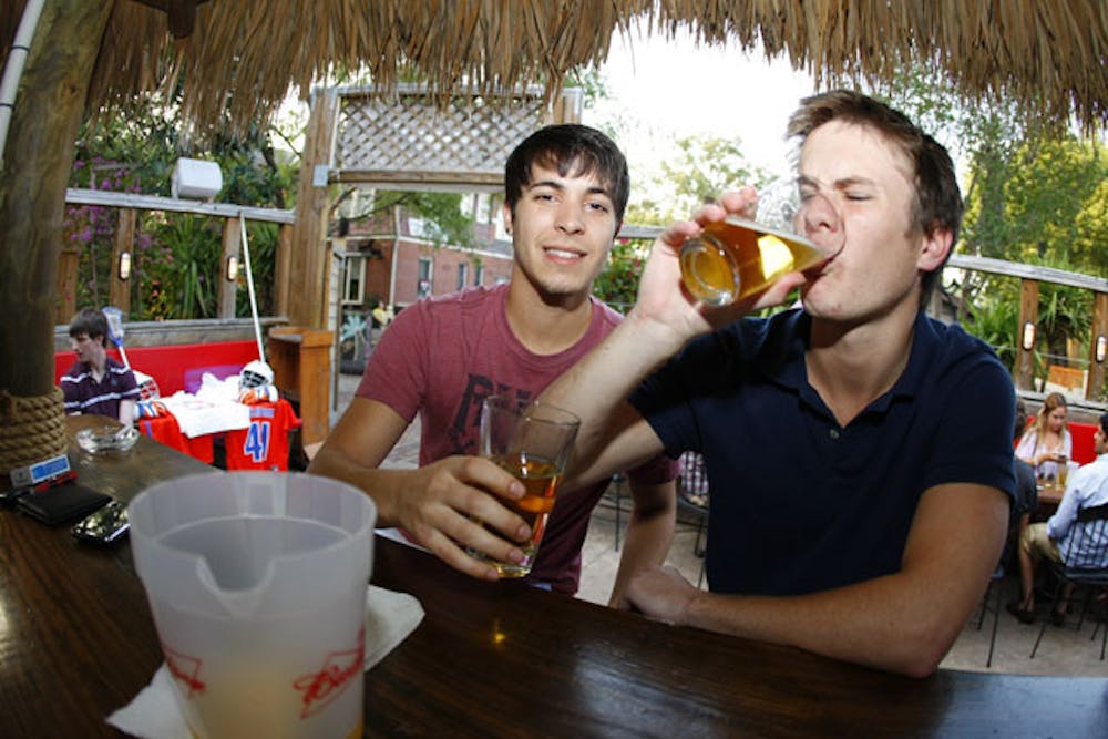 <p>Nicholas Sherman, a 21-year-old agribusiness major, and Justin Howell, a 21-year-old finance major, drink beer at 101 Cantina on Tuesday. The city denied 101 Cantina's request to extend boundaries to sell alcohol in its parking lot on Cinco de Mayo.</p>