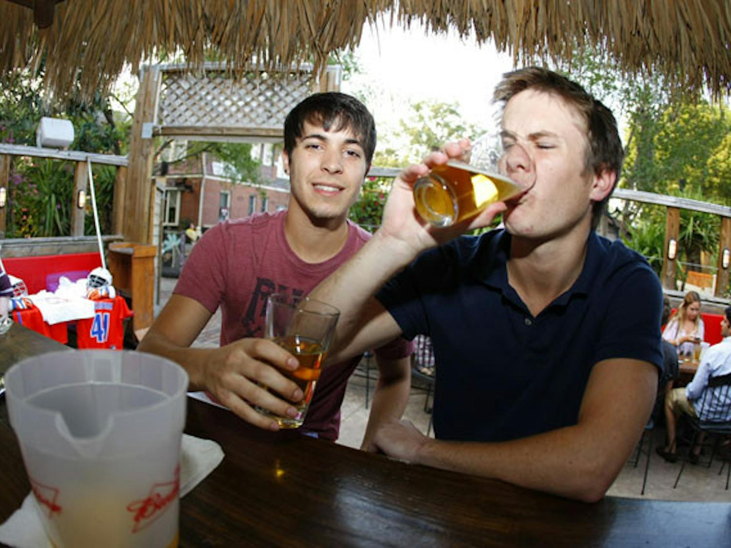 Nicholas Sherman, a 21-year-old agribusiness major, and Justin Howell, a 21-year-old finance major, drink beer at 101 Cantina on Tuesday. The city denied 101 Cantina's request to extend boundaries to sell alcohol in its parking lot on Cinco de Mayo.