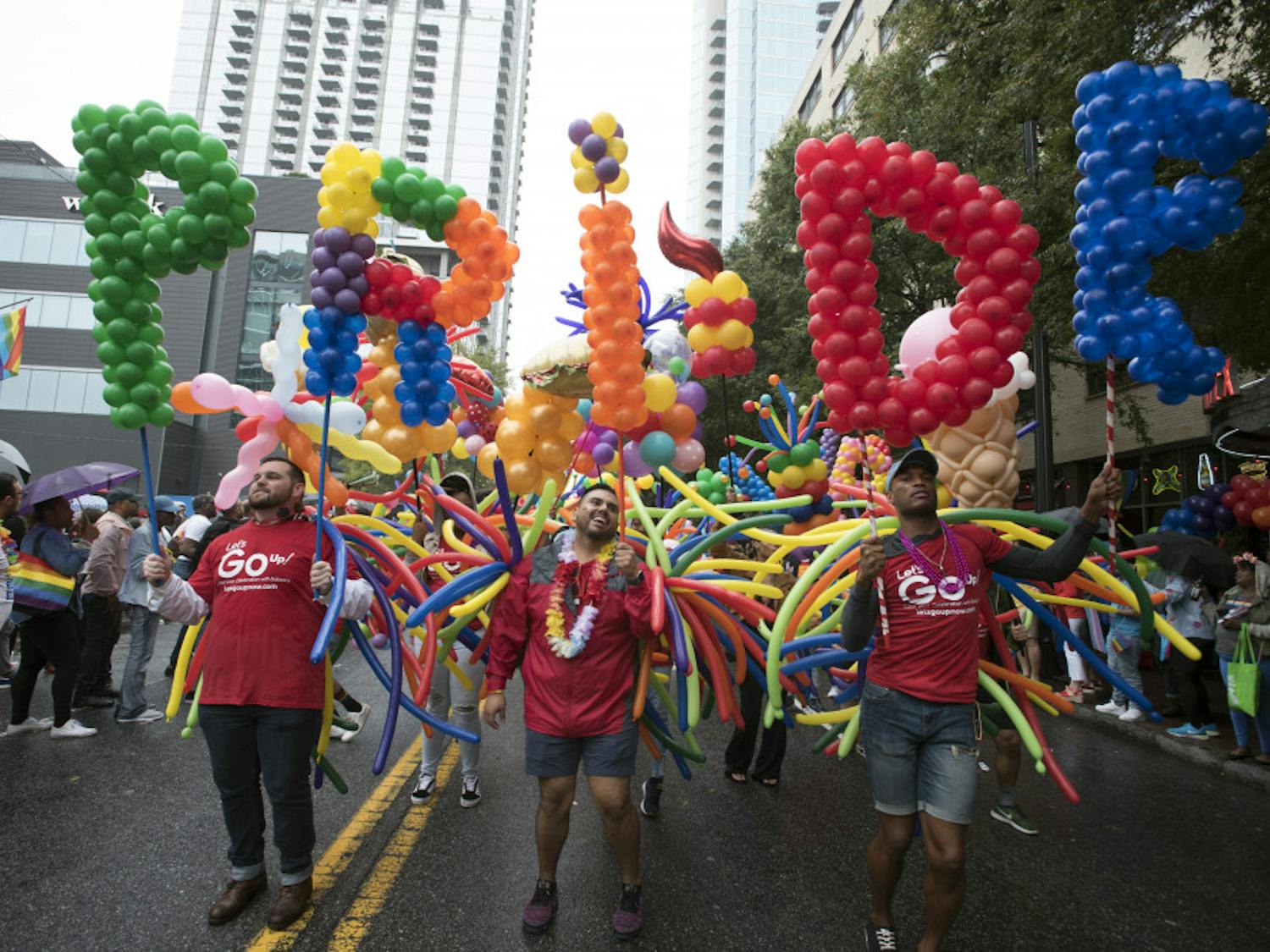 Employees from a local business supporting LGBTQ rights march during the city's annual Gay Pride parade on Sunday, Oct. 13, 2019, in Atlanta. (AP Photo/Robin Rayne)