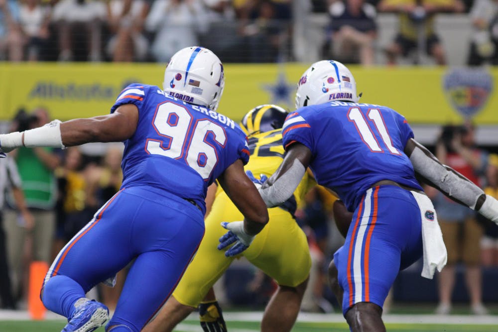 Cece Jefferson (96) and Vosean Joseph make a tackle during Florida's 33-17 loss against Michigan on Sept. 2, 2017, at AT&amp;T Stadium in Arlington, Texas.