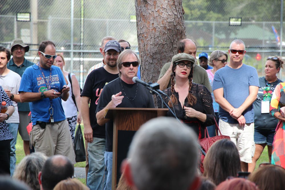 Tom Petty's brother and daughter, Bruce and Adria Petty stand behind the podium at the dedication of Tom Petty Park on Oct. 20, 2018. Both gave made statements and thanked the community before the unveiling of the new sign.