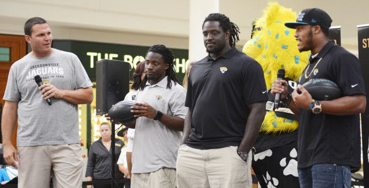 Former Jaguars offensive tackle Tony Boselli (far left) chats with current players (left to right) Ace Sanders, Sen’Derrick Marks and Josh Evans before an autograph-signing session at the Oaks Mall on Wednesday.