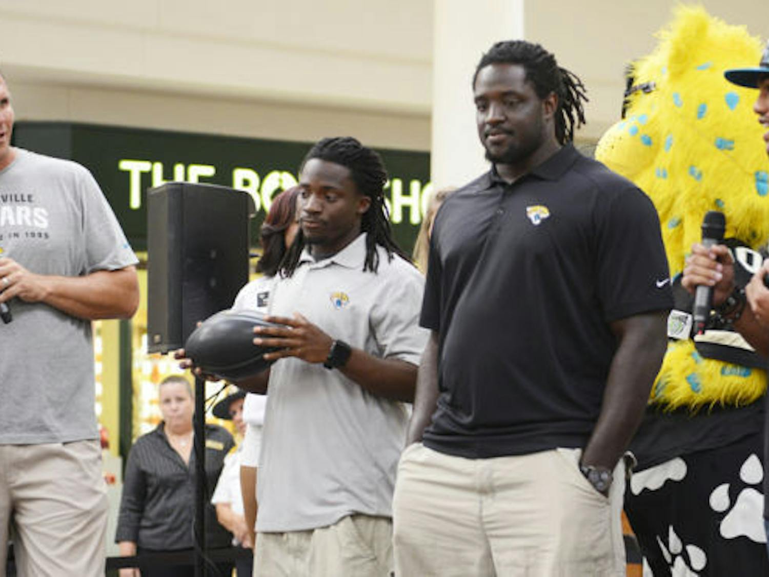 Former Jaguars offensive tackle Tony Boselli (far left) chats with current players (left to right) Ace Sanders, Sen’Derrick Marks and Josh Evans before an autograph-signing session at the Oaks Mall on Wednesday.