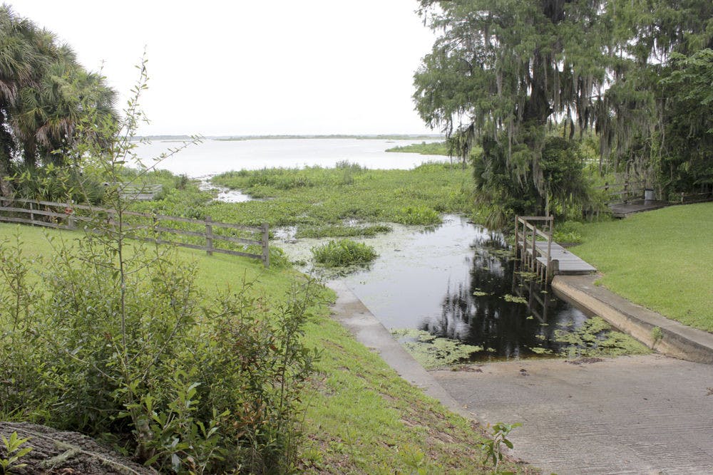 Rain falls on Orange Lake at the Heagy Burry Park boat ramp Monday. Sinkholes along the bottom of Orange Lake are lowering water levels, preventing boats from safely launching on to the lake.
