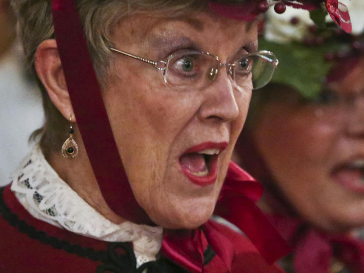 Karen Caraway carols with the Gainesville Harmony Show Chorus during the annual Holiday Tree Lighting ceremony at the Historic Thomas Center on Dec. 5, 2015. She has sung with the choir for 23 years.