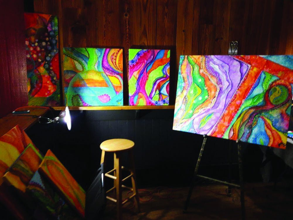 <p dir="ltr">Local artist Brian Wilson’s painting on display at High Dive’s Arts Market on Saturday evening. Wilson said that his paintings represent the energy of a place, individual or feeling</p>
