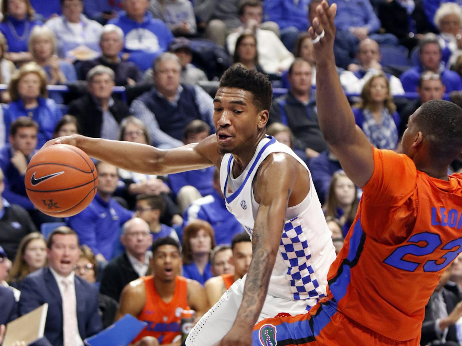 Kentucky's Malik Monk, left, looks for an opening on Florida's Justin Leon during the first half of an NCAA college basketball game, Saturday, Feb. 25, 2017, in Lexington, Ky. (AP Photo/James Crisp)
