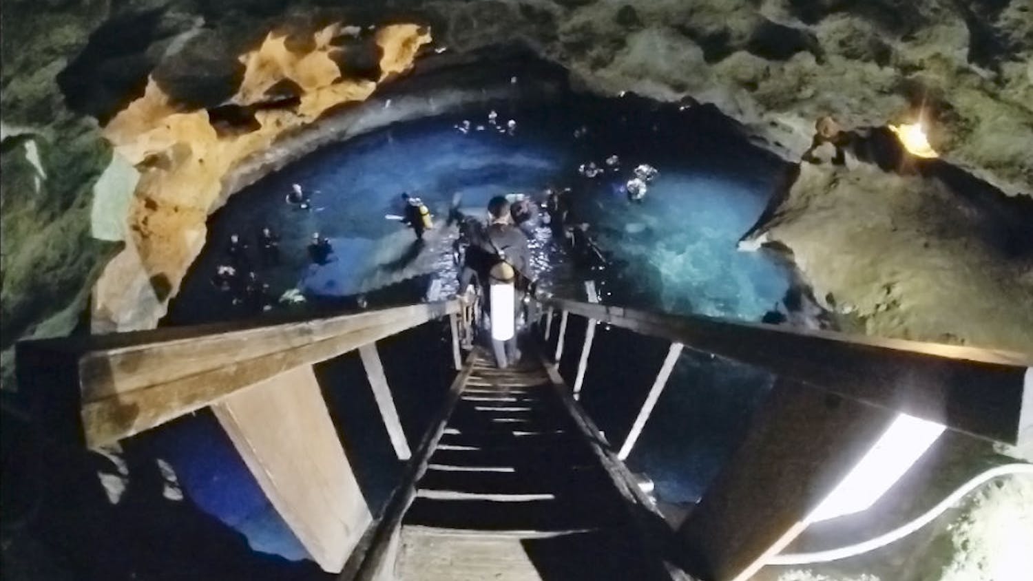 A diver descends into Devil’s Den before Scuba Monkey Dive Center’s third annual night underwater Easter egg hunt Saturday. Hidden in the springs were more than 300 different dyed eggs and three golden eggs. Prizes included a Tusa Nitrox dive computer, a Big Blue 750 lumens LED light and an Epcot DiveQuest trip.