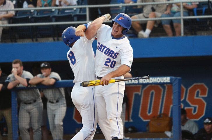 UF's Peter Alonso (right) celebrates with teammate Harrison Bader after Bader's solo home run in the first inning of Florida's 14-3 win against the South Carolina Gamecocks on April 11 at McKethan Stadium.