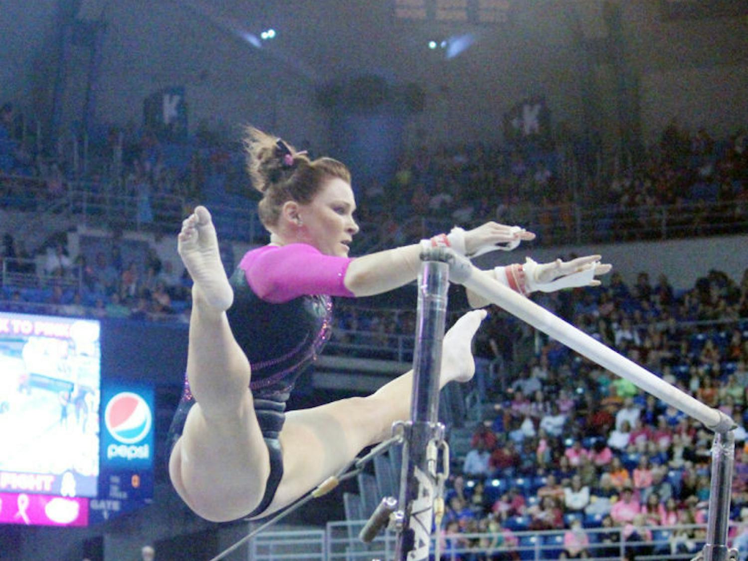 Bridget Sloan performs a bar routine during Florida’s 198.125-197.625 win against LSU on Feb. 21 in the O’Connell Center.