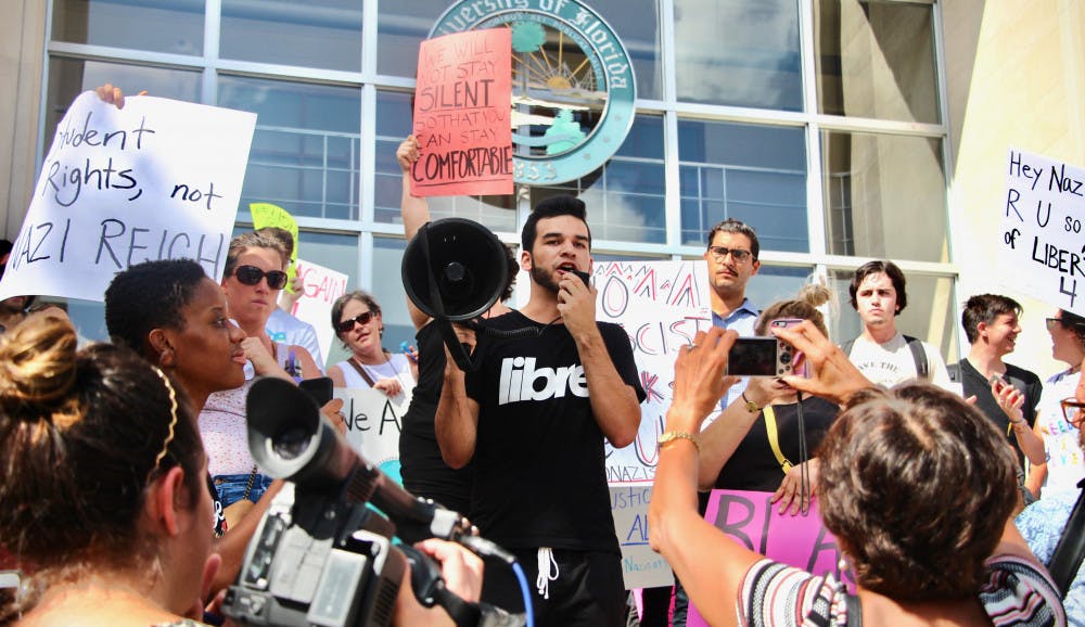 Chad, a 20-year-old political science and sociology junior who declined to release his last name, holds a megaphone to address the crowd and viewers tuning into the protest that “the University of Florida does not care about us (protesters and minorities).” He also stated they would stay on the steps of Tigert Hall until someone came to speak to them.