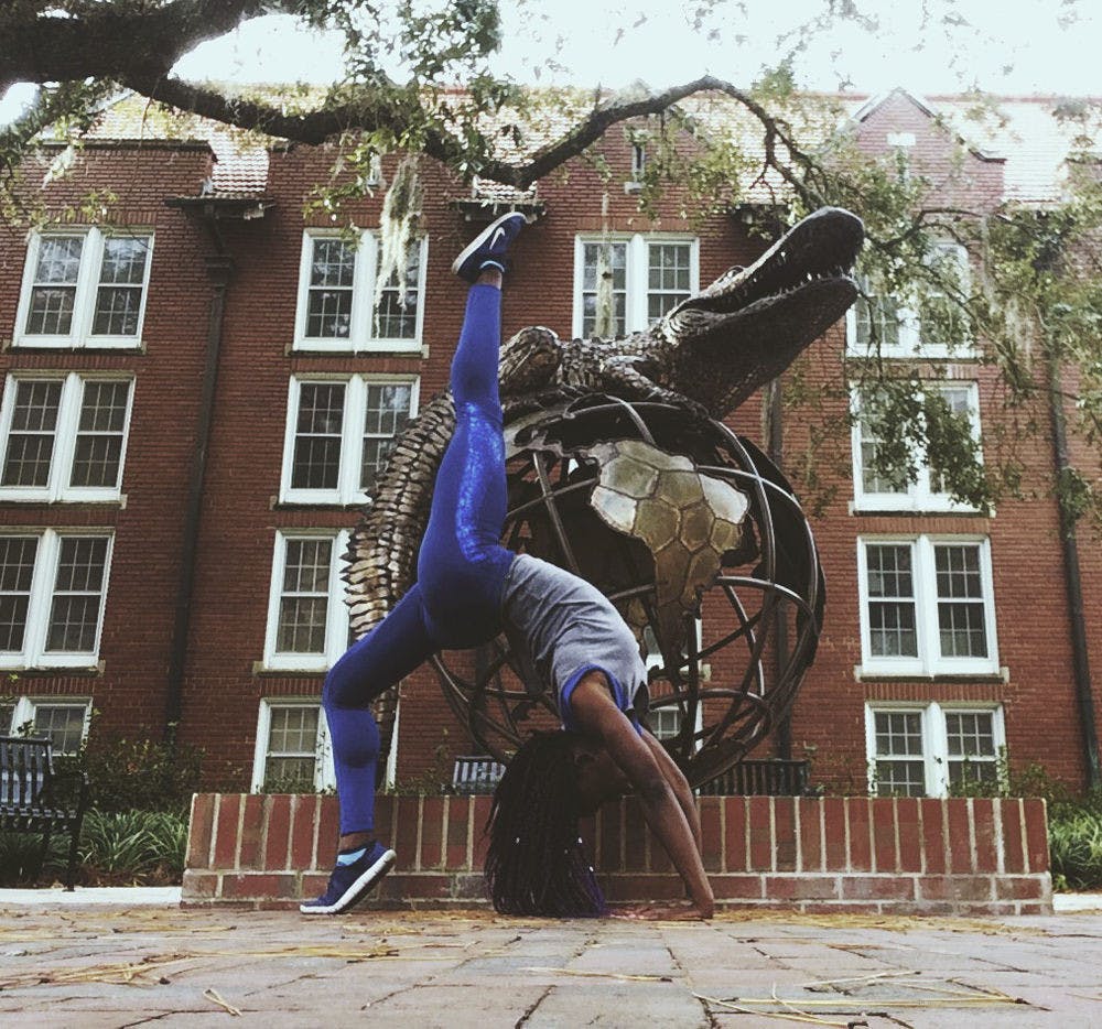 Tawanya Norwood poses on UF’s campus for a self-portrait for her Instagram, @th33besticanbe. Norwood hopes to become a Nike model by getting the company’s attention with athletic photos on social media.