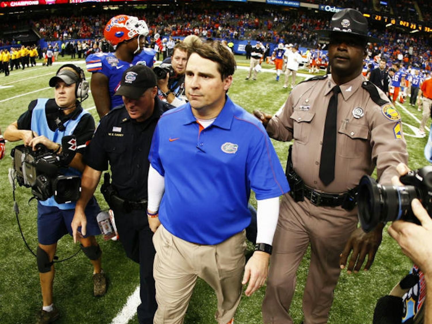 Coach Will Muschamp walks off the field following Florida’s 33-23 loss to Louisville in the Sugar Bowl&nbsp; on Jan. 2 at the Superdome in New Orleans. Muschamp owns an 18-8 record in two seasons with the Gators.