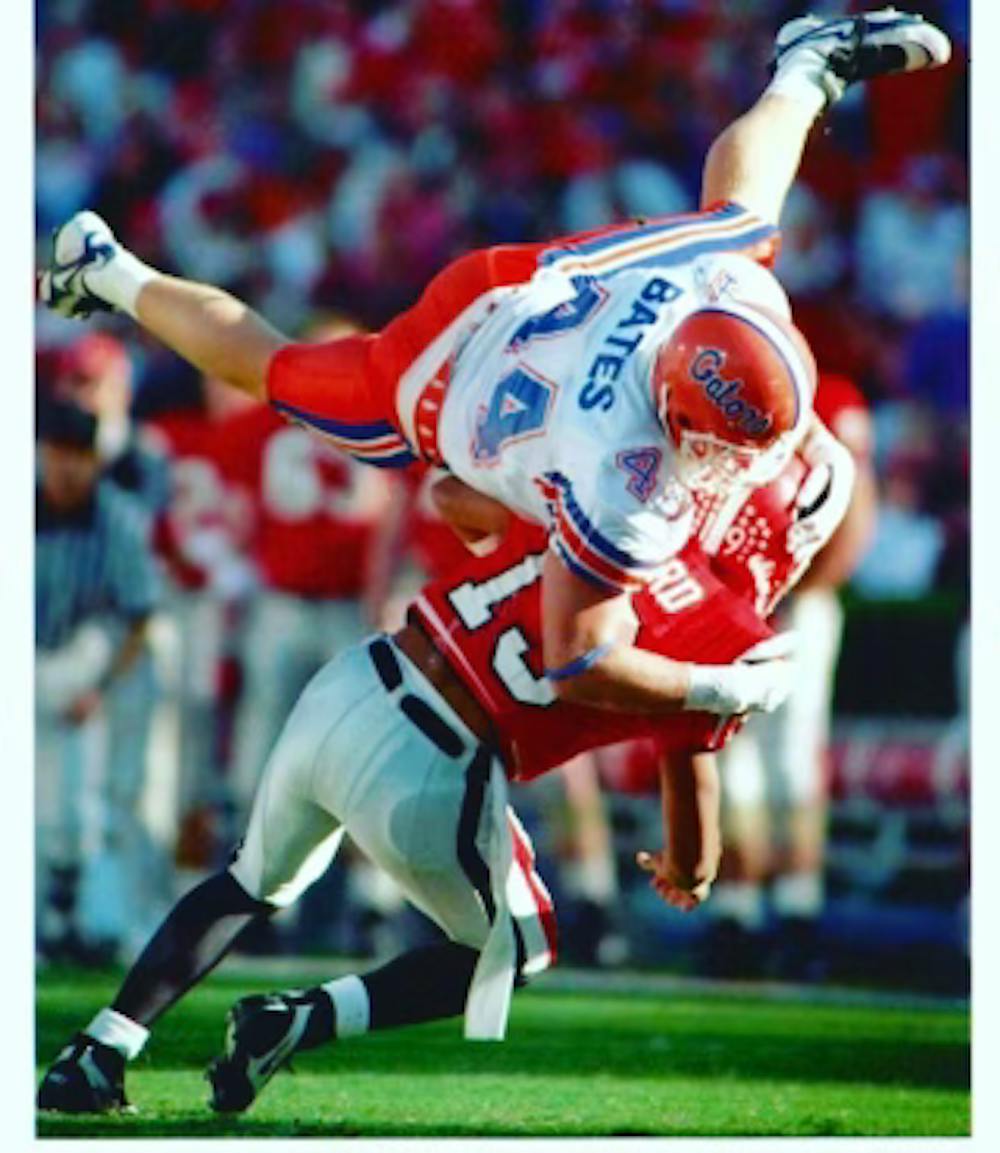 James Bates, a linebacker on the Florida football team from 1992-1996, tackles a Georgia Bulldog during the 1995 game in Athens, Georgia. Courtesy to the Alligator from James Bates.