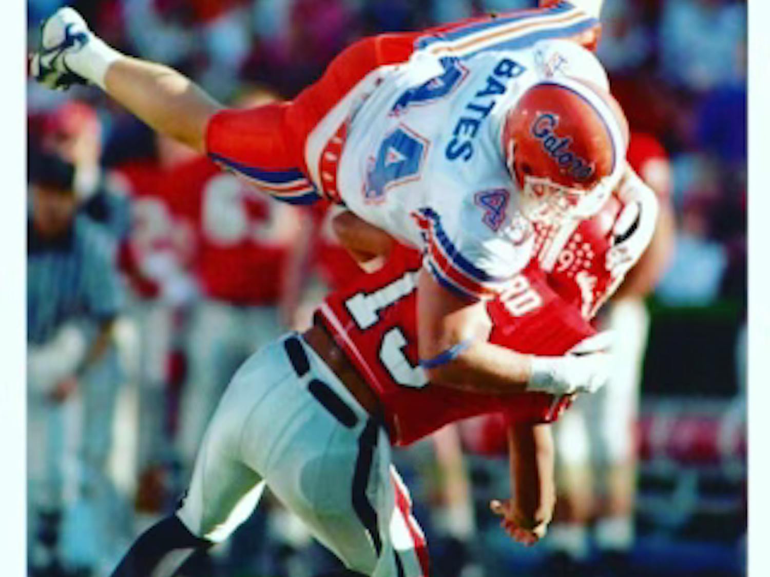 James Bates, a linebacker on the Florida football team from 1992-1996, tackles a Georgia Bulldog during the 1995 game in Athens, Georgia. Courtesy to the Alligator from James Bates.