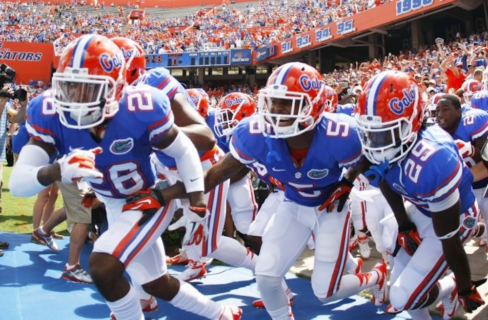 <p>Sophomore defensive backs De'Ante Saunders (26), Marcus Roberson (5), and freshman defensive back Rhaheim Ledbetter (29) prepare to run onto the field to face Kentucky on Sept. 22 at Ben Hill Griffin Stadium. No. 10 UF hosts No. 4 LSU on Saturday.</p>