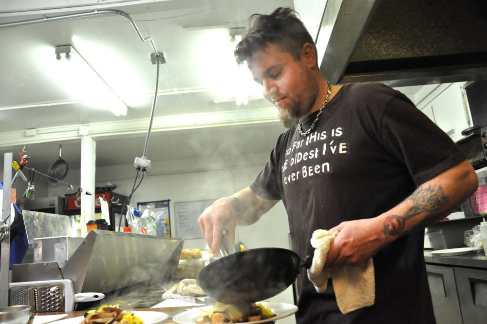 Chuck Hurley fills a lunch order at Kickin’ Devil Cafe, 2017 NE 27th Ave. He’s been working as a chef for more than half his life in Gainesville, New York and Paris.